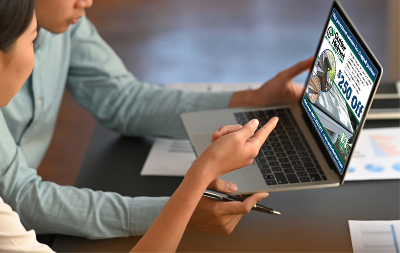 two people looking at a display ad on a laptop. place digital display ads in reputable publications