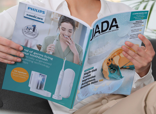 Woman reading The Journal of American Dental Association Magazine