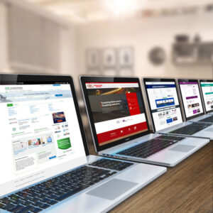 computers on a table with publishers webpages showing on the screens 