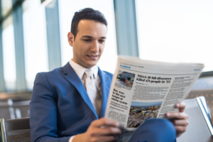 man holding newspaper find out the incredible benefits of print advertising